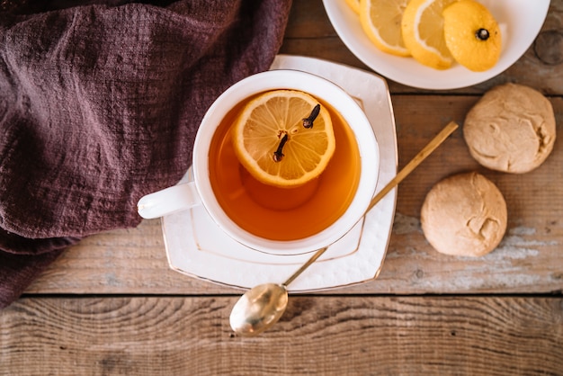 Top view tea with slices of lemon and cookies Free Photo