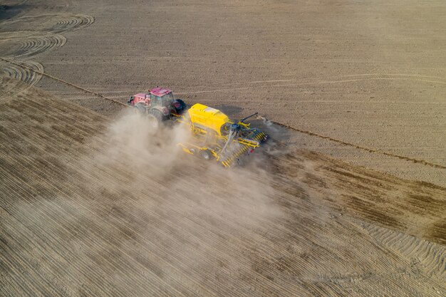 Premium Photo Top View Of Tractor Planting Corn Seed In Field High