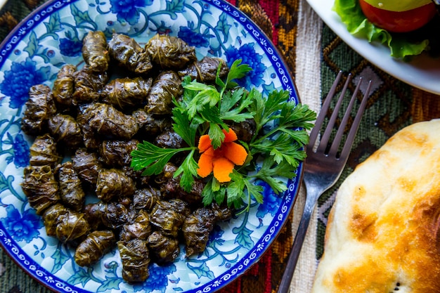 Top view a traditional azerbaijani dish dolma meat in grape leaves with ...