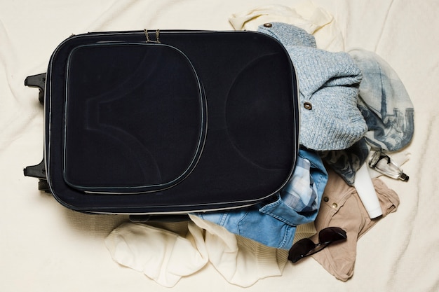 travel bag on top of suitcase