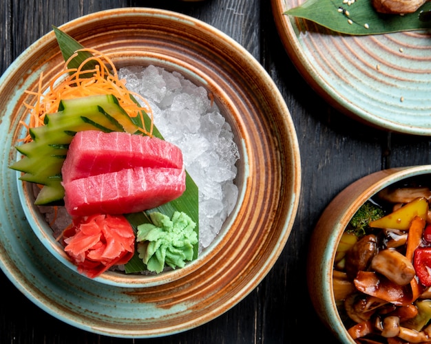 Top view of tuna sashimi slice cutting with cucumbers ginger and wasabi
