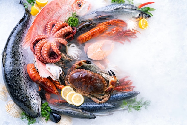 Premium Photo | Top view variety of fresh luxury seafood on ice ...