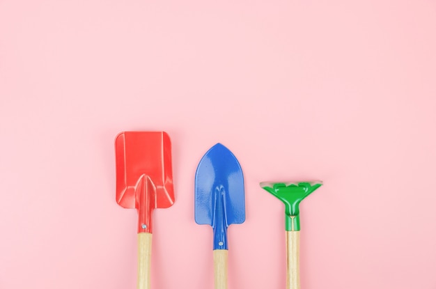 Top view with of gardener tools overhead on pink pastel background, flat lay Premium Photo