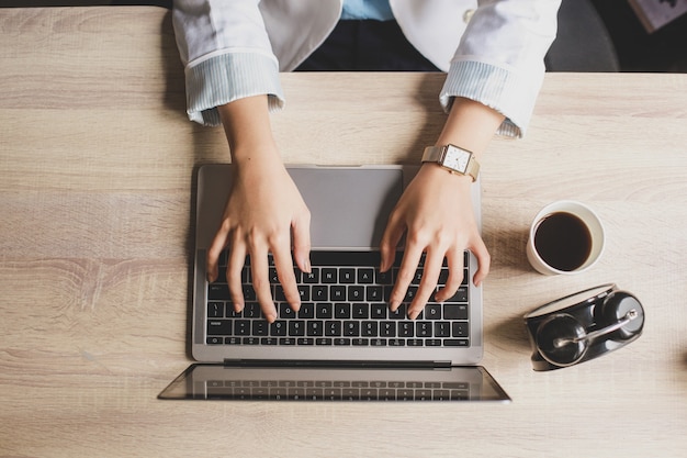 Premium Photo | Top view of woman hand typing on laptop keyboard on a ...