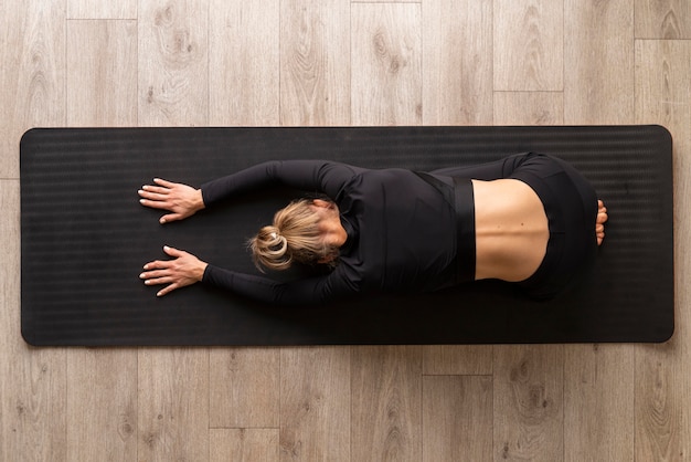 Free Photo | Top view woman practicing yoga