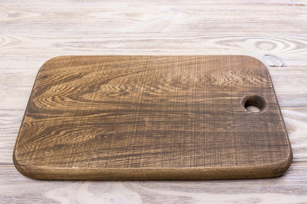 Premium Photo | Top view of wooden cutting board on old wooden table