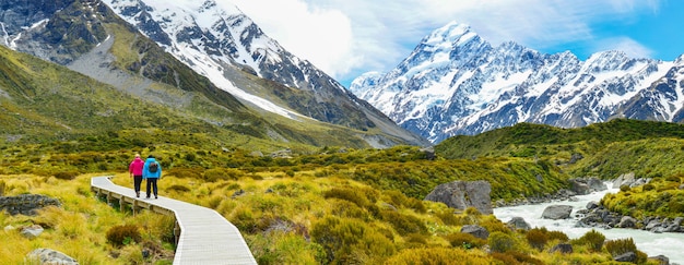 Premium Photo | Tourists hiking on hooker valley track in mount cook ...