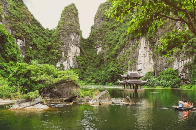 Premium Photo | Tourists on rowboat at the trang an landscape complex ...