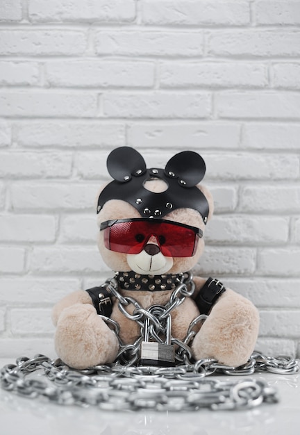 Premium Photo The Toy Bear Dressed In Leather Straps Harness Accessory For Bdsm Chained With A 5008