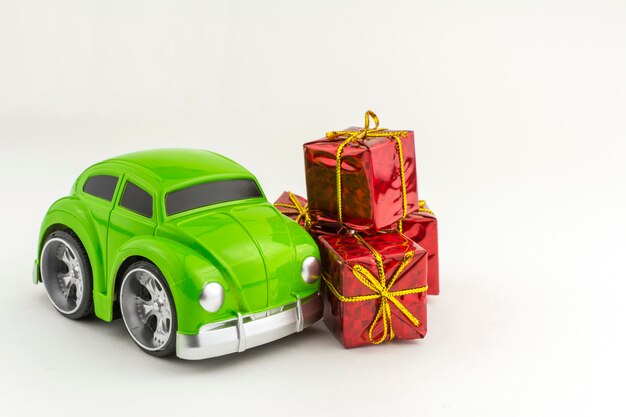 Premium Photo | Toy green car with and small gift boxes.