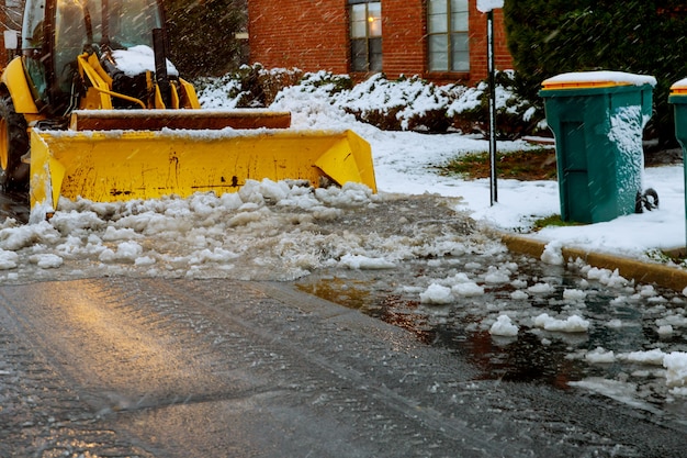 Tractor loader cleans snow after a snowfall Premium Photo