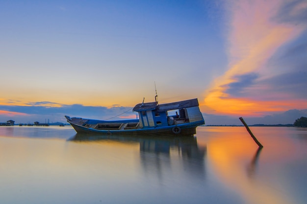 Premium Photo | Traditional fishing boat in a fishing village at sunset ...