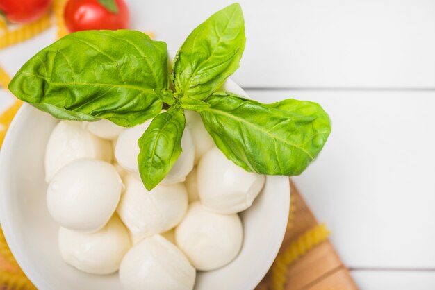Traditional italian mozzarella cheese with basil leaves ...