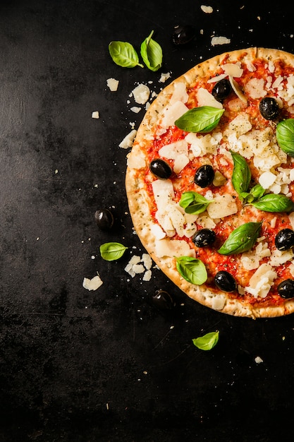 Traditional italian pizza on dark table Premium Photo