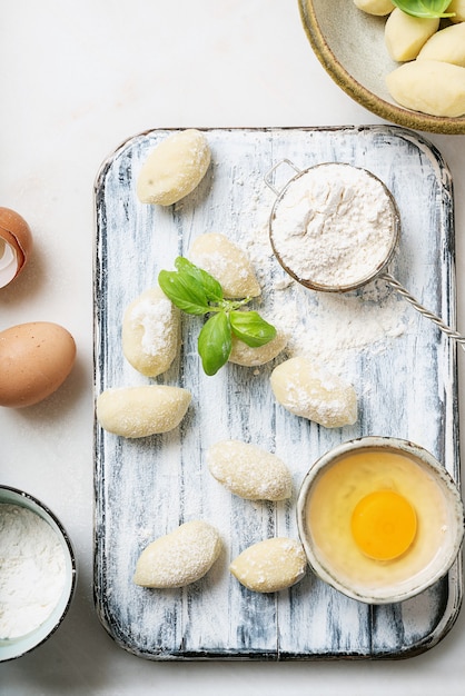Premium Photo | Traditional italian potato gnocci decorated with basil ...