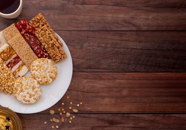 Traditional mawlid sweets on brown wooden table, copyspace for text Premium Photo