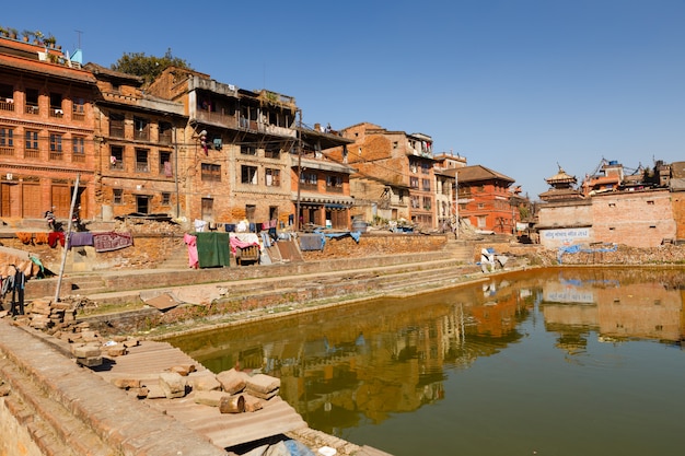 Traditional nepalese newar houses near the green pond in bhaktapur, nepal Premium Photo