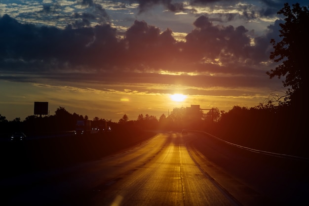 Premium Photo | Traffic on road at beautiful sunrise sky with clouds in ...