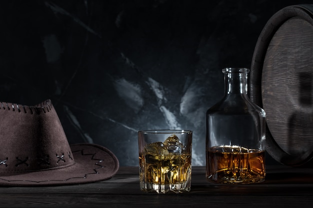 Premium Photo | Transparent glass with whiskey cowboy hat and decanter