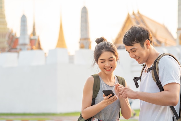Traveler asian couple direction on location map in bangkok, thailand Free Photo