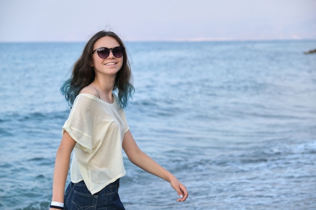 New beauty teenager Premium Photo Trendy Beautiful Teenager Girl With Long Colored Blue Hair In Sunglasses And Shorts Walking Along Sea Beach