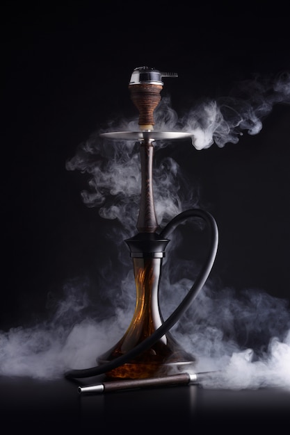 Premium Photo | Trendy hookah with cloud of smoke on black background