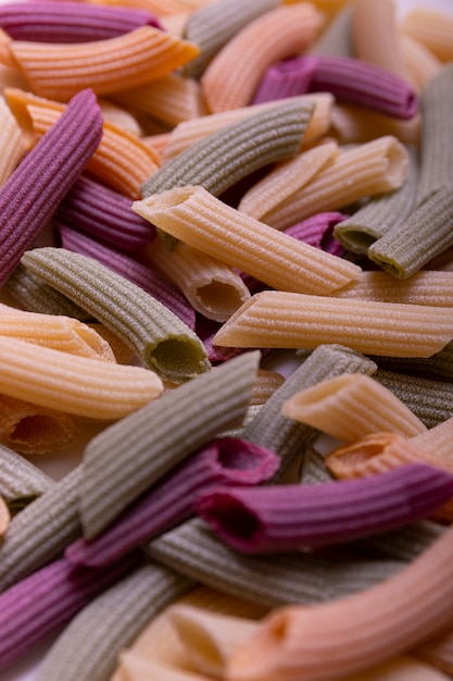 Premium Photo | Tri-color penne pasta. tomato, spinach and wheat pastas.