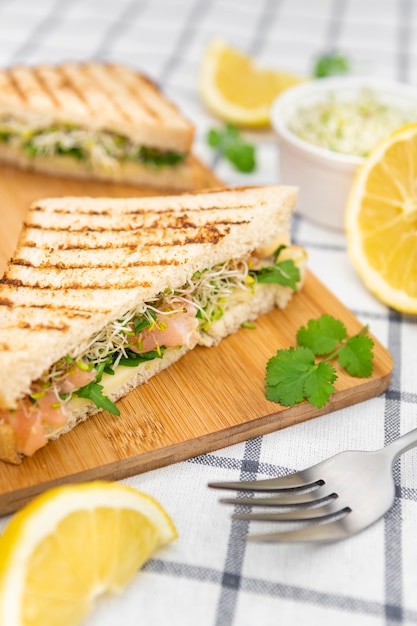 Free Photo | Triangular sandwiches on chopping board with fork and parsley