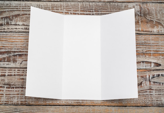 Trifold white template paper on wood texture . Free Photo