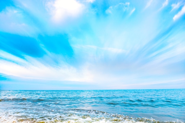 Premium Photo | Tropical beach and blue sea with waves, white clouds on ...