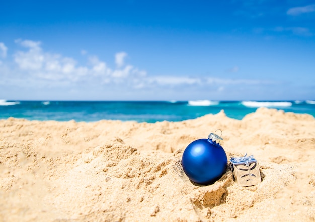 Premium Photo | Tropical beach with blue christmas ball