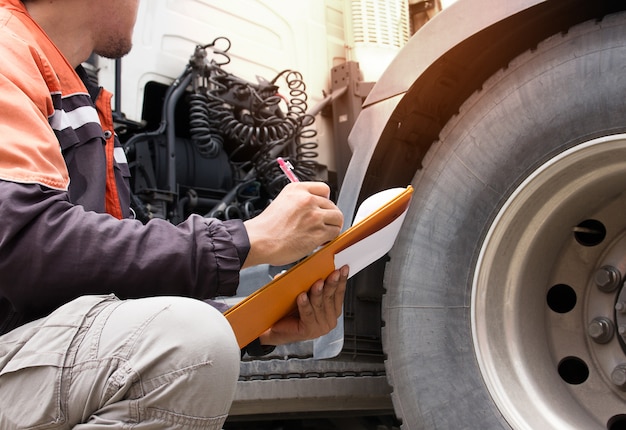 Premium Photo | Truck driver are holding a clipboard with checking a ...