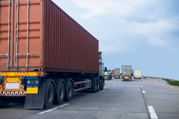 Truck on highway road with red container, transportation concept.,import,export logistic industrial transporting land transport on the asphalt expressway with blue sky Premium Photo