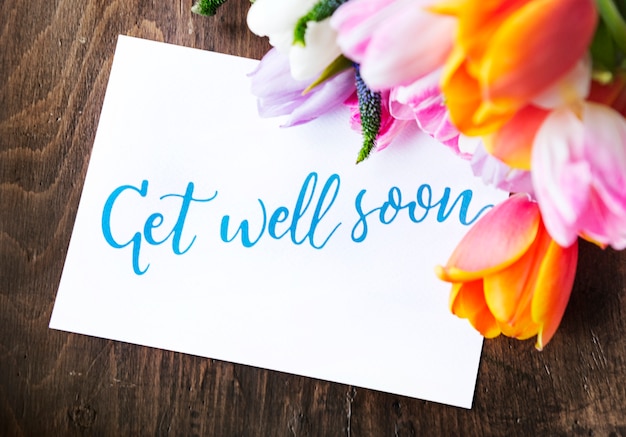 Premium Photo | Tulips flowers bouquet with get well soon wishing card