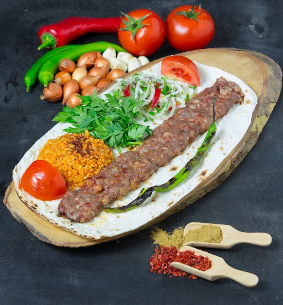 Premium Photo | Turkish adana kebab with vegetables on the plate