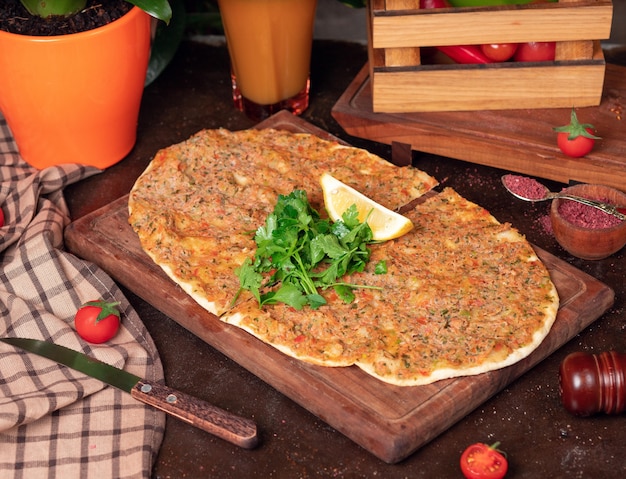 Turkish dishes: lahmacun, turkish pizzas, lemon, parsley Free Photo