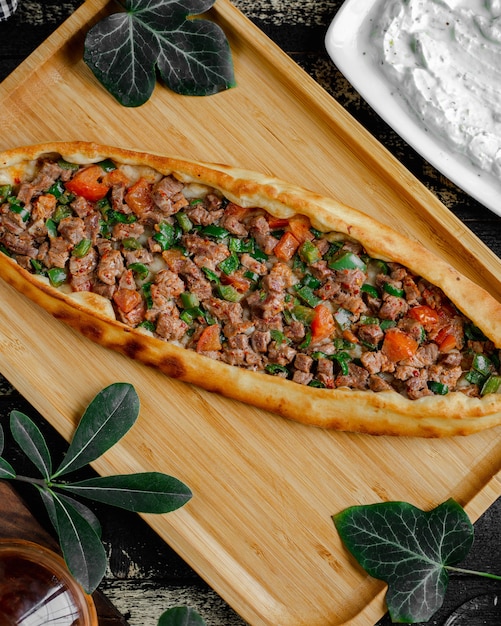 Free Photo Turkish pide pizza with meat and vegetable stuffing inside