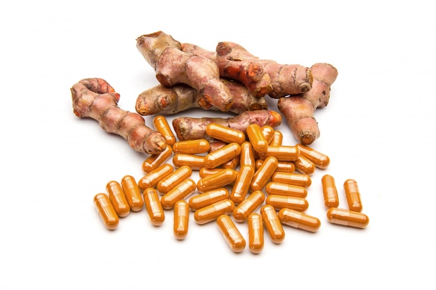 Premium Photo | Turmeric or curcuma longa and herbal capsule isolated