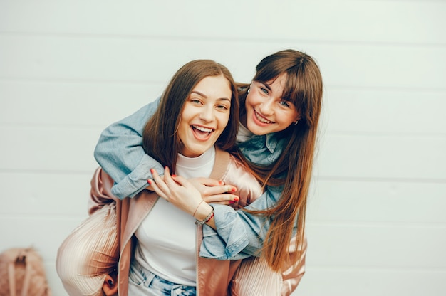 Two beautiful girls are walking around the city Free Photo