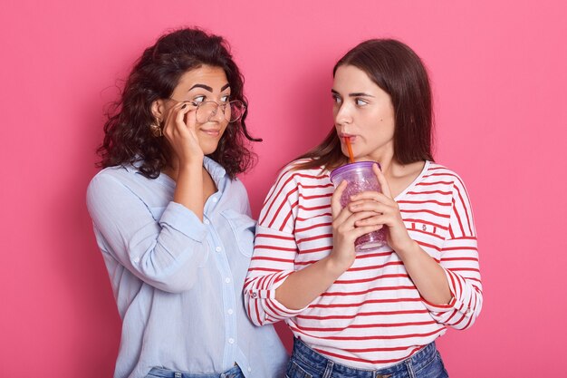 Premium Photo Two Beautiful Girls Posing Together Against Pink Wall 