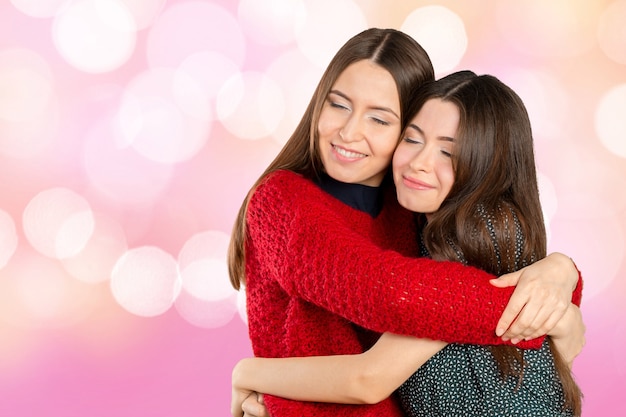 Premium Photo Two Beautiful Sisters Hugging Each Other And Smiling