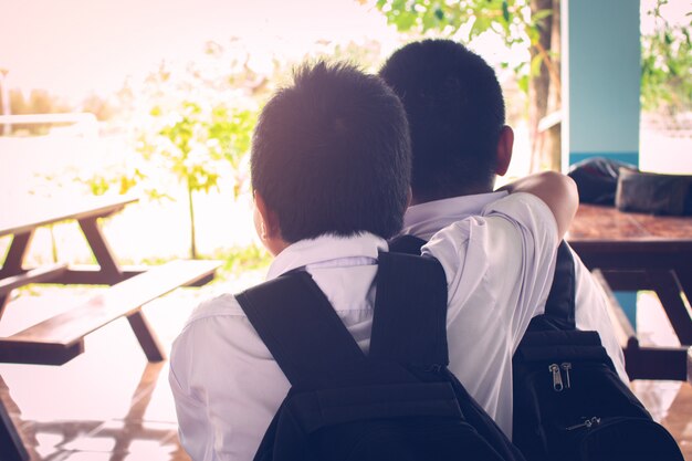 Two Best Boy Friends Thinking And Hugging With Love Premium Photo