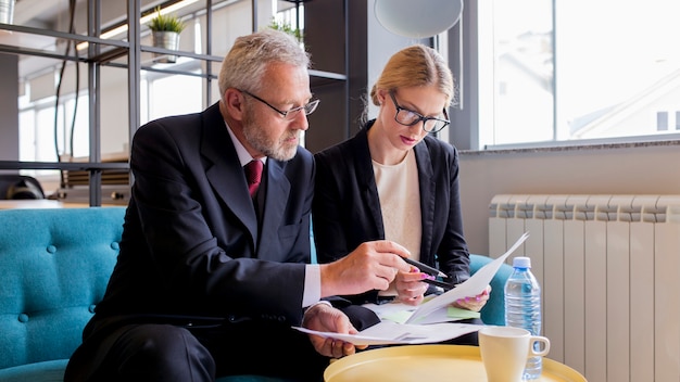 Two businesspeople discussing contract in the office Free Photo