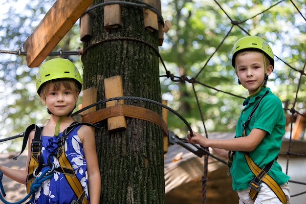 Premium Photo | Two children, boy and girl in protective harness and ...