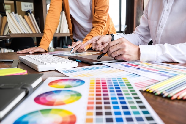 Two creative graphic designer working on color selection and color swatches Premium Photo