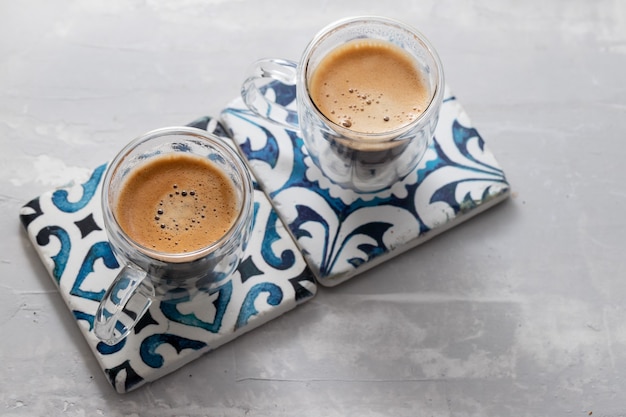 Two cups of coffee on ceramic background Premium Photo
