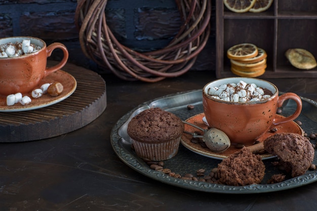 Download Premium Photo Two Cups Of Hot Chocolate With Marshmallows And Muffins Close Up