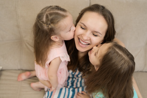 Two Daughters Kissing Their Mommy Free Photo