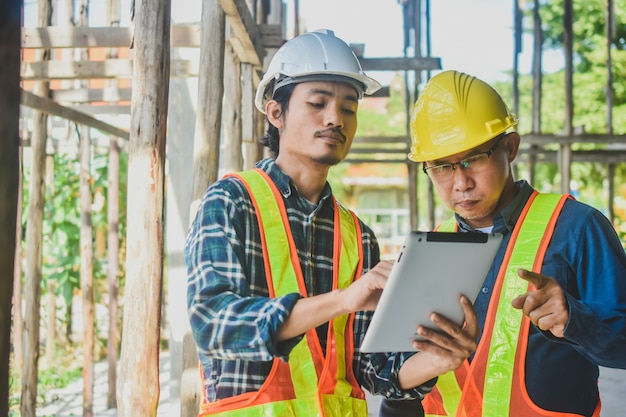 Premium Photo | Two engineer tablet inspection site construction real ...