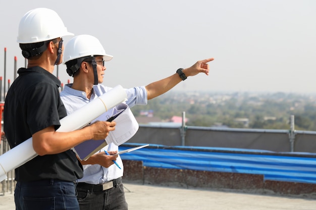 Premium Photo | Two engineers work on the construction site. they are